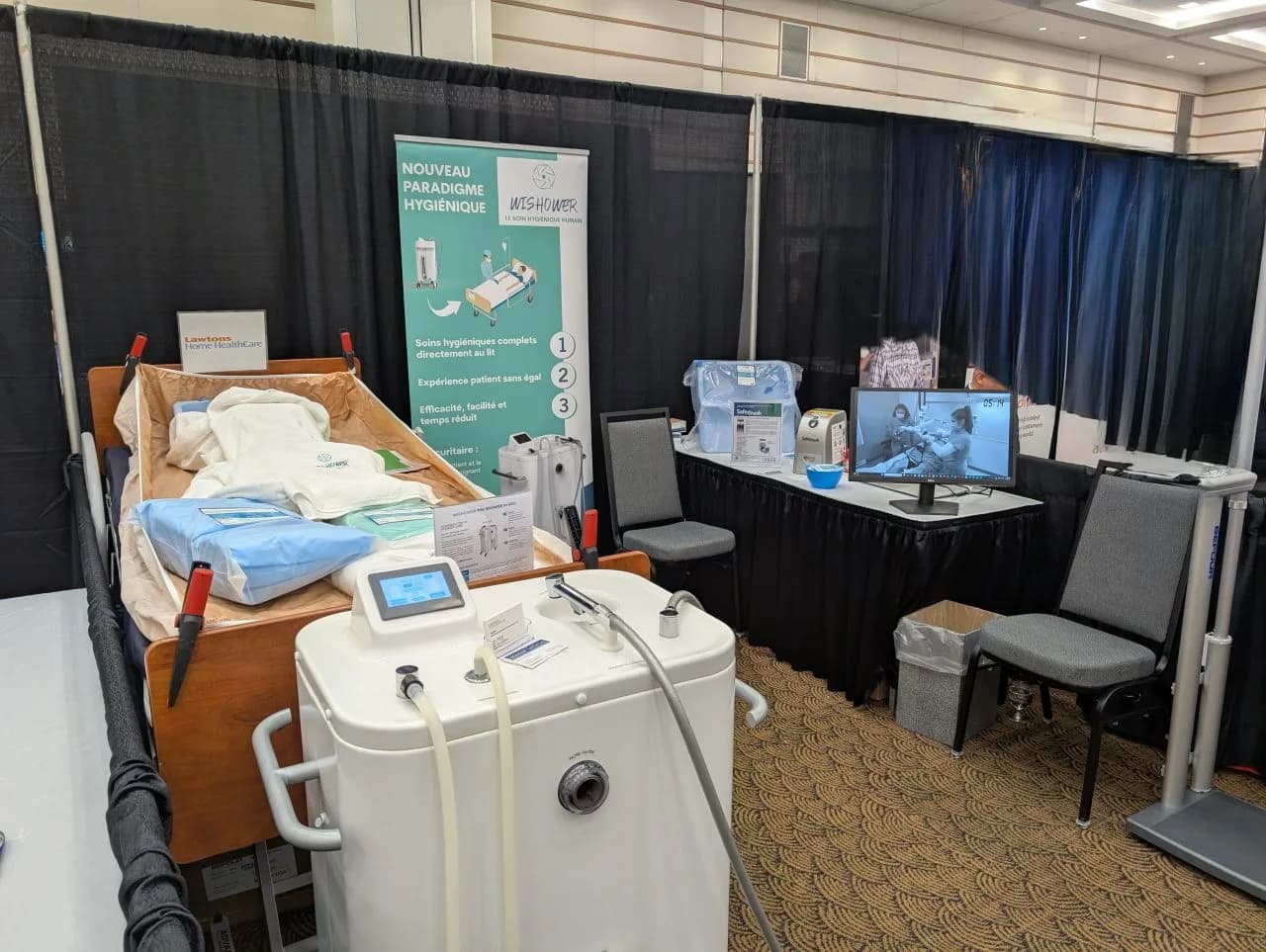 The LIOMAR Medical booth at CMBEC47 in Fredericton, with the Wishower beside a care bed