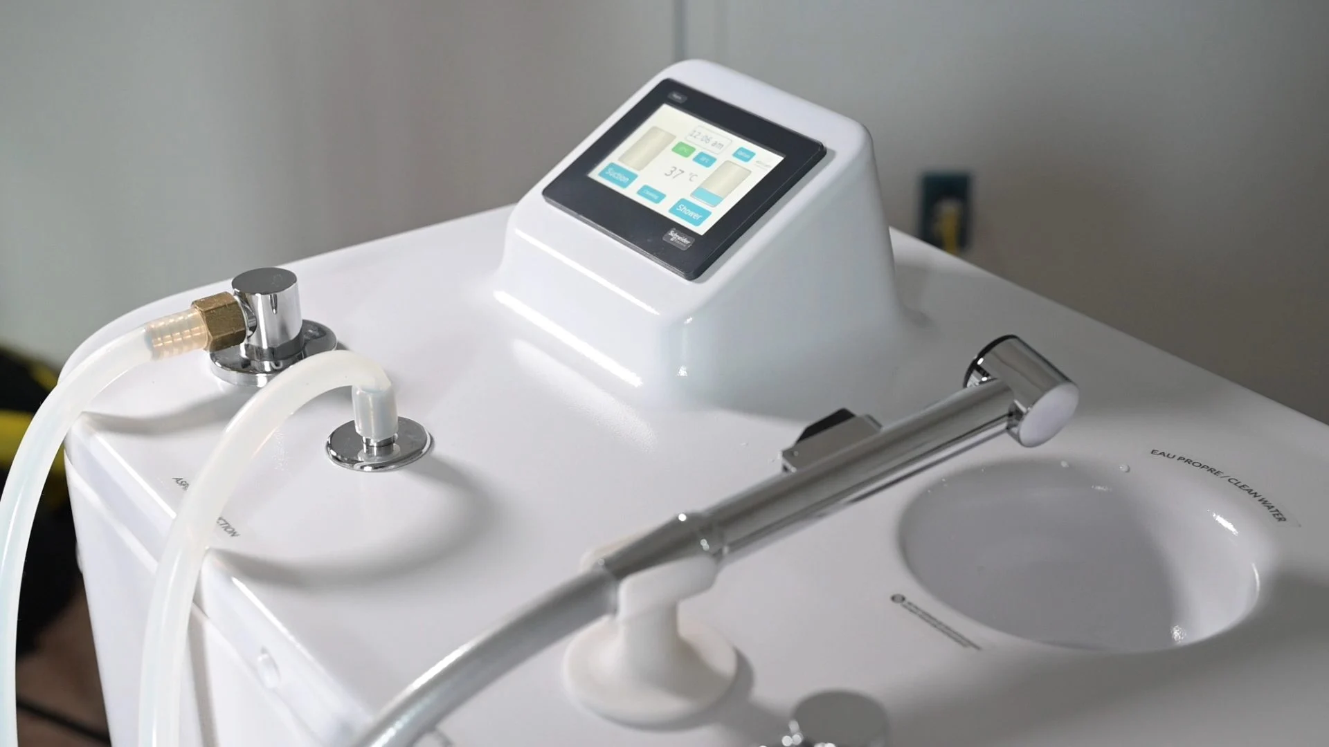 Close-up of the Wishower touchscreen and hand-held shower