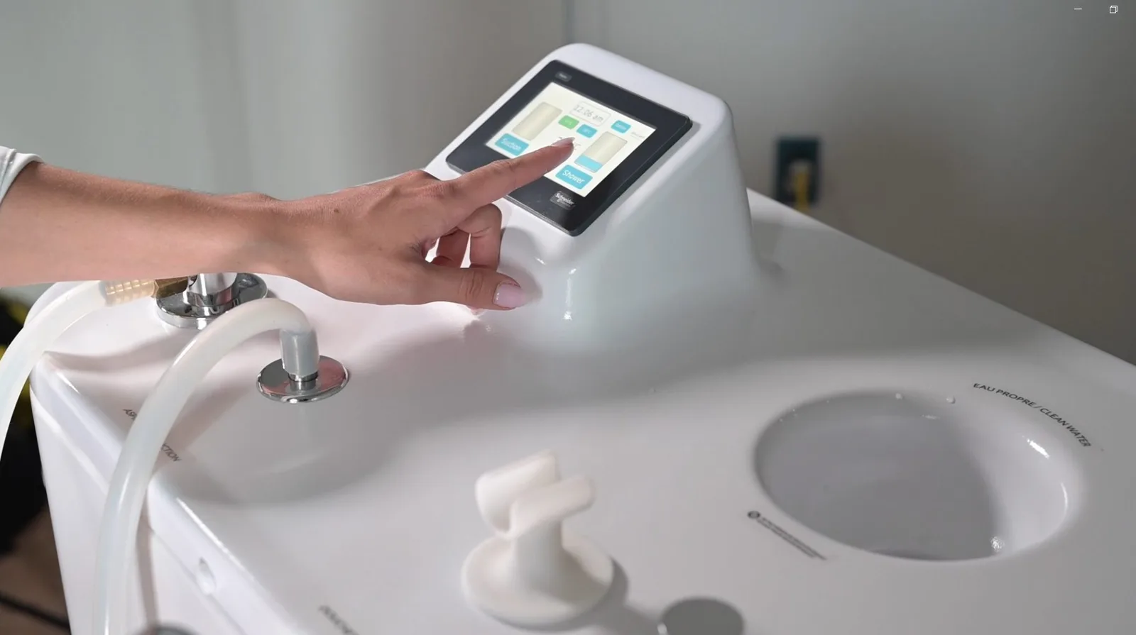 A caregiver using the Wishower touchscreen