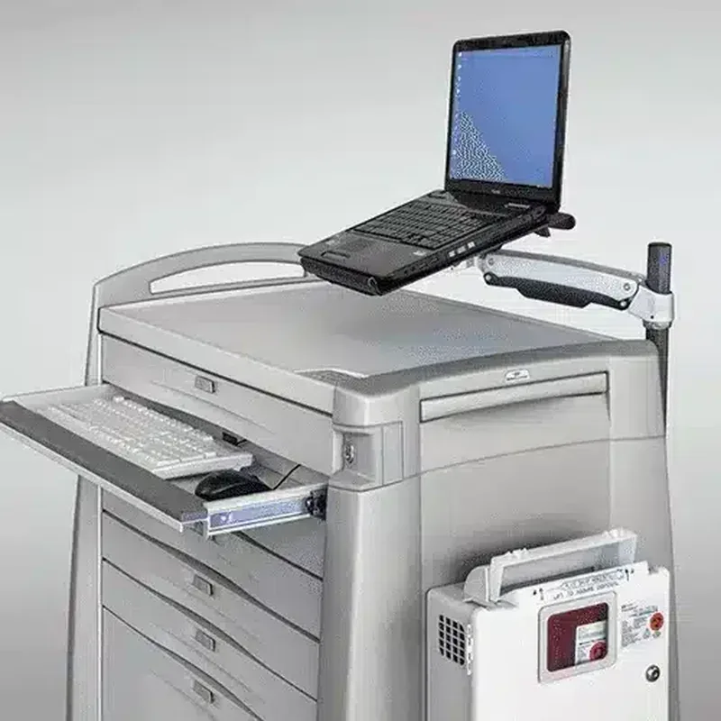 AX Series arm mounted at the back of a Capsa medication cart, holding a laptop