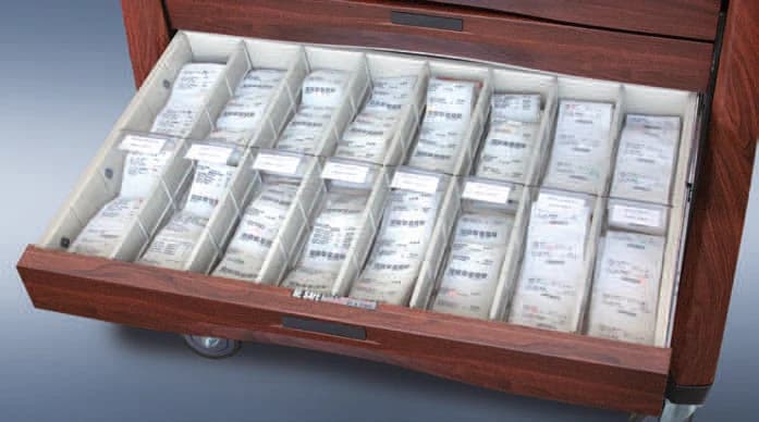 Pouch packaging in the drawer of an Avalo Woodblend cart in Northern Cherry