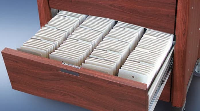 Punch cards in the drawer of an Avalo Woodblend cart in Northern Cherry