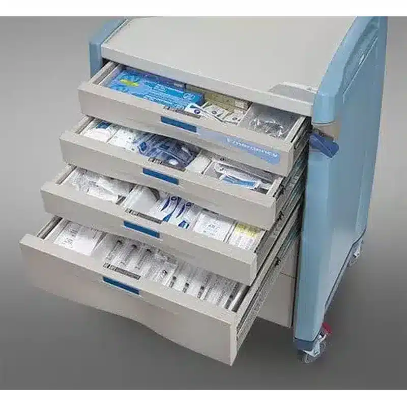 An emergency crash cart with its drawers pulled open, showing medications and airway supplies organised in labelled compartments.